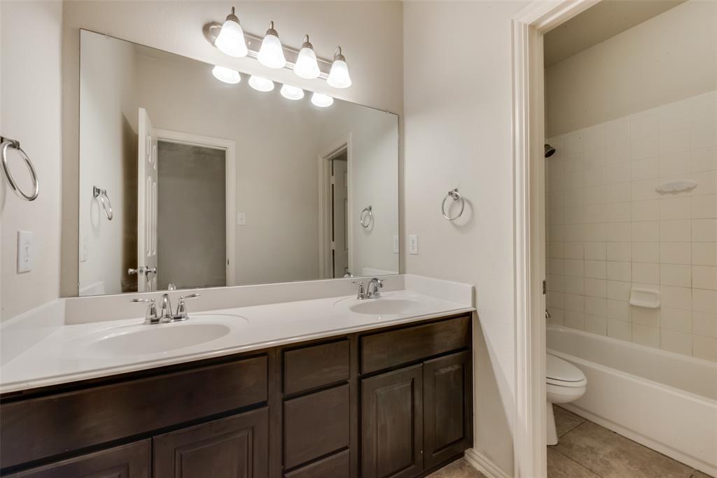 10620 Sexton Drive McKinney, TX 75072 - Photo 16 of 17 a bathroom with a double vanity sink and a mirror