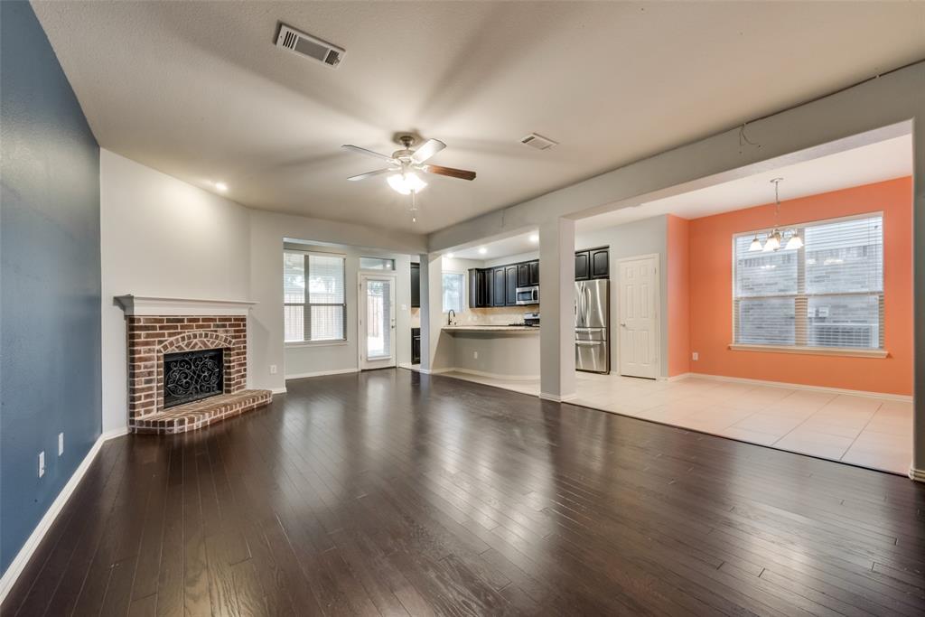 10620 Sexton Drive McKinney, TX 75072 - Photo 2 of 17 a view of an empty room with wooden floor and a fireplace