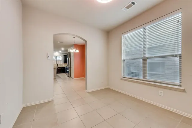 a view of a hallway with a window and a kitchen