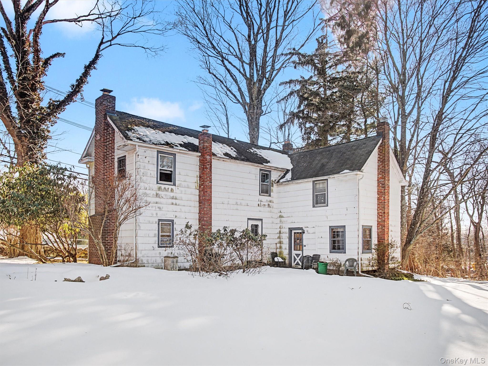 62 North Airmont Road Suffern, NY 10901 - Photo 3 of 15 a view of a white house with a yard covered in snow