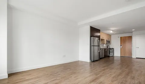 a view of a kitchen with a sink and a refrigerator
