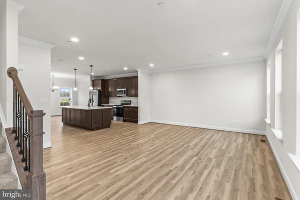 a view of kitchen with kitchen island wooden floor and center island