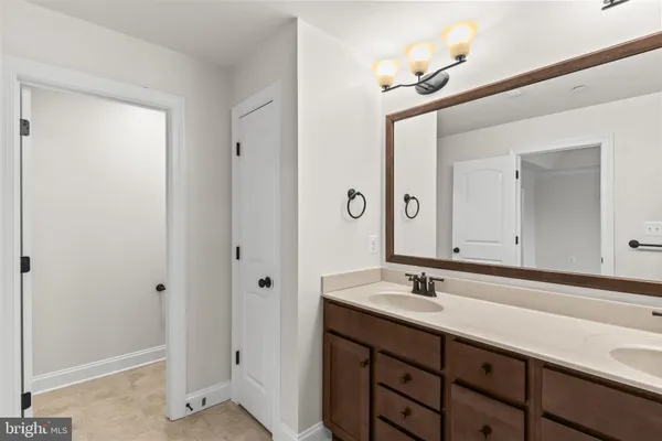 a bathroom with a sink vanity and a mirror