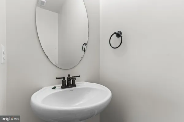 a bathroom with a sink and mirror