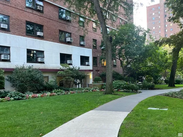 a view of a house with a backyard and garden