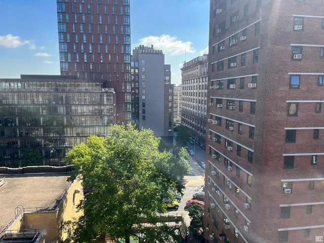 a sign board with a building in the background