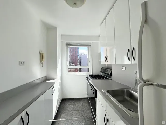 a kitchen that has a sink and a stove