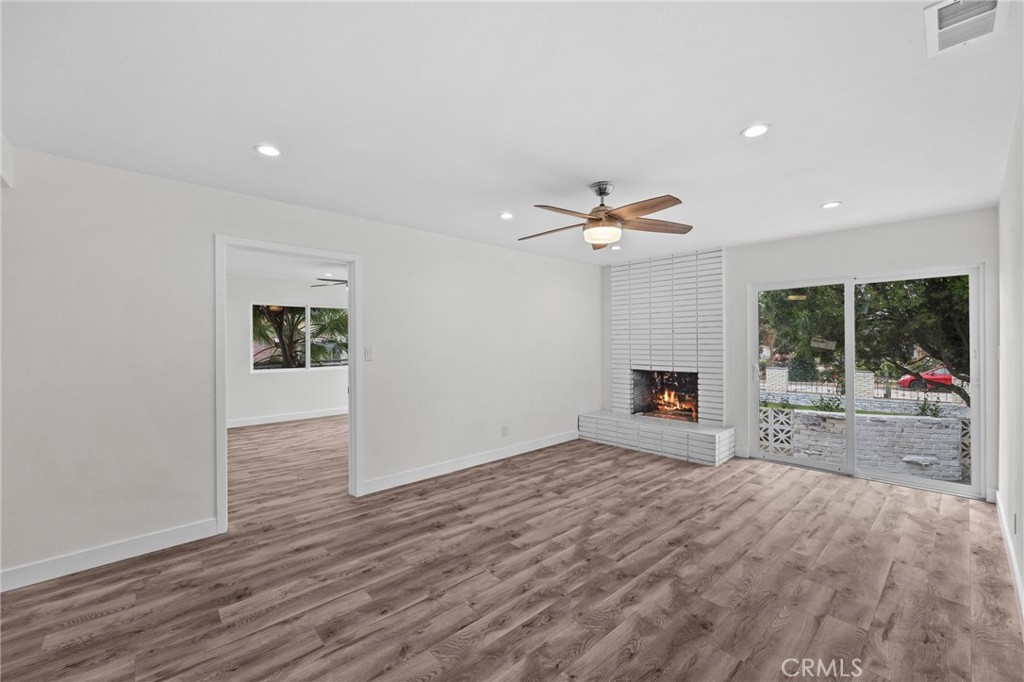 19404 Cheshire Street Rialto, CA 92377 - Photo 13 of 30 a view of empty room with wooden floor and fireplace