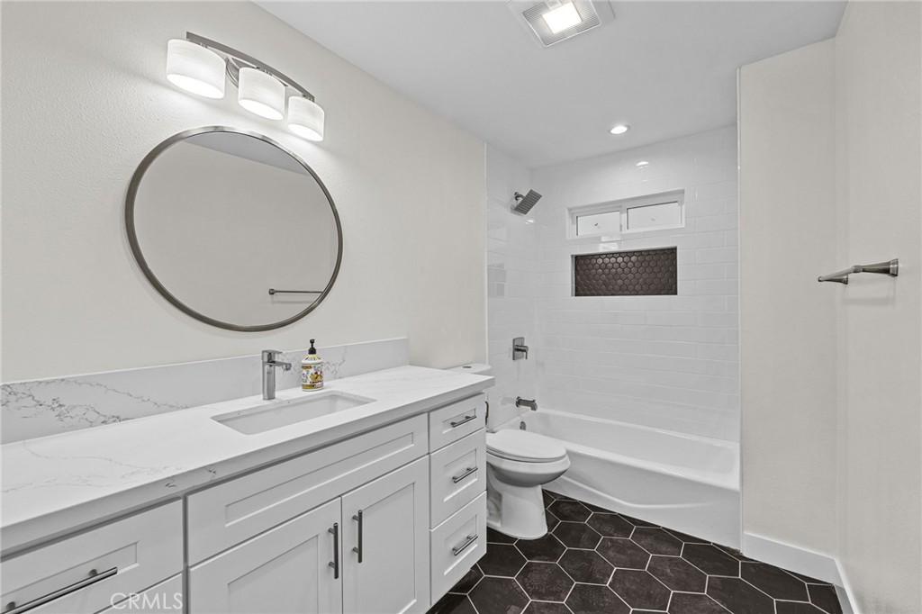 19404 Cheshire Street Rialto, CA 92377 - Photo 15 of 30 a bathroom with a double vanity sink mirror and toilet