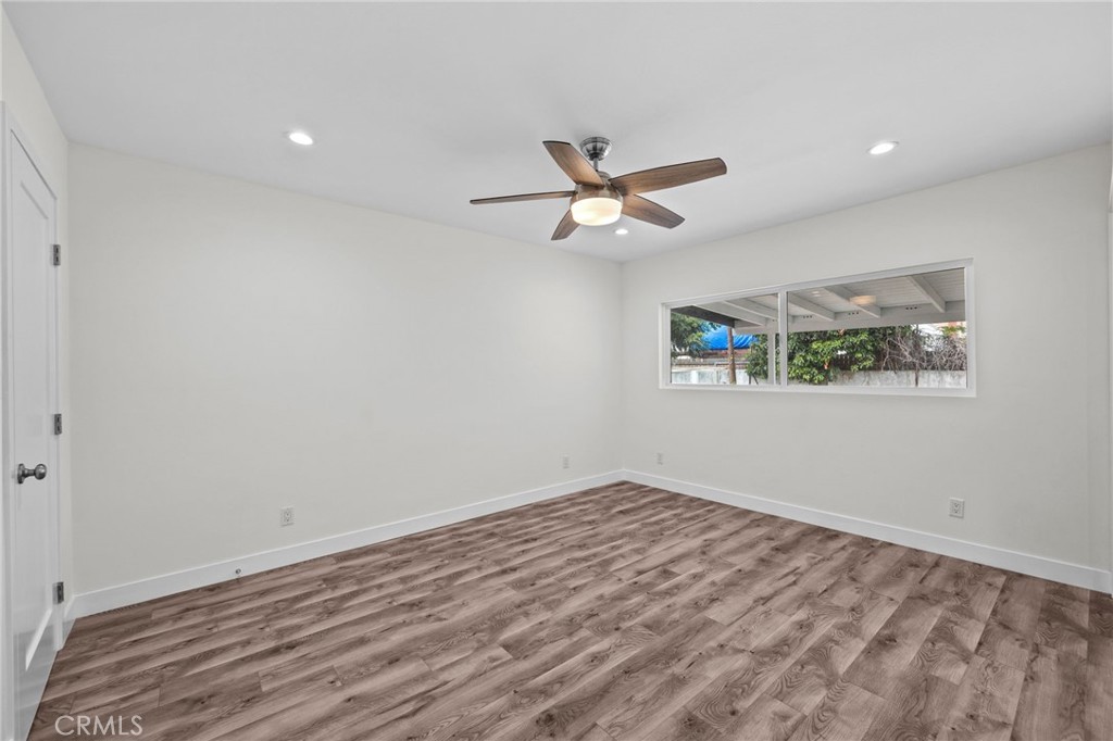 19404 Cheshire Street Rialto, CA 92377 - Photo 18 of 30 a view of a big room with wooden floor and a chandelier fan