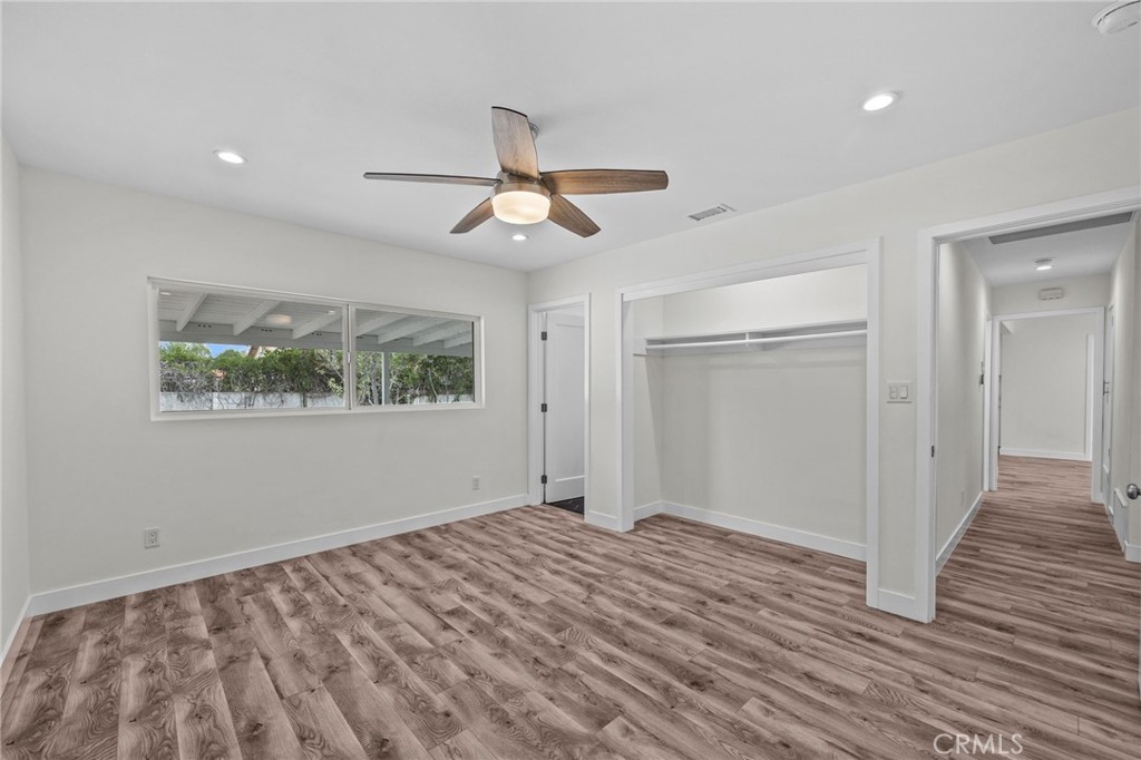 19404 Cheshire Street Rialto, CA 92377 - Photo 19 of 30 a view of empty room with wooden floor and fan