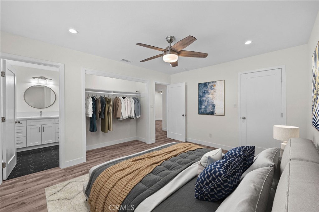 19404 Cheshire Street Rialto, CA 92377 - Photo 20 of 30 a bedroom with a bed and a chandelier