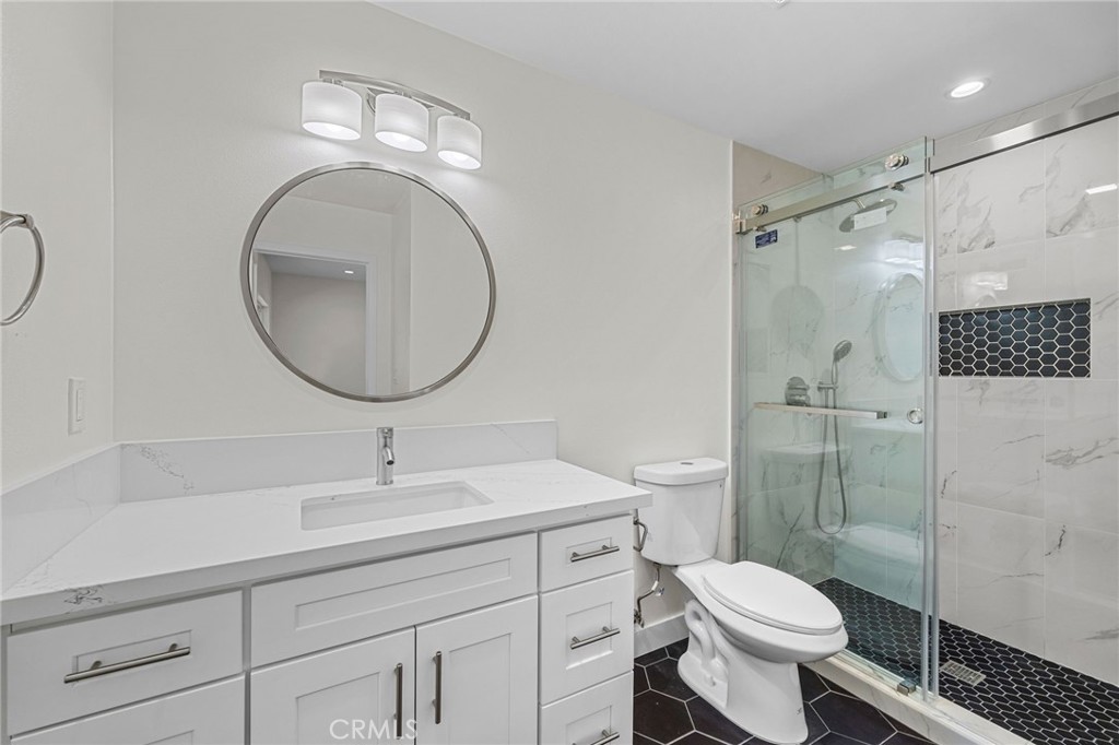 19404 Cheshire Street Rialto, CA 92377 - Photo 22 of 30 a bathroom with a sink toilet and shower