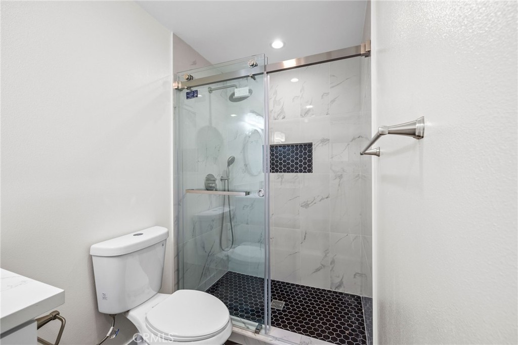 19404 Cheshire Street Rialto, CA 92377 - Photo 23 of 30 a bathroom with a shower toilet and sink