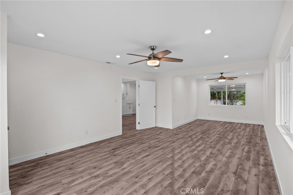 19404 Cheshire Street Rialto, CA 92377 - Photo 3 of 30 a view of a livingroom with a ceiling fan & hardwood floor