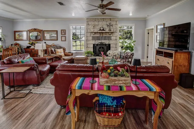 a living room with furniture a fireplace and a flat screen tv