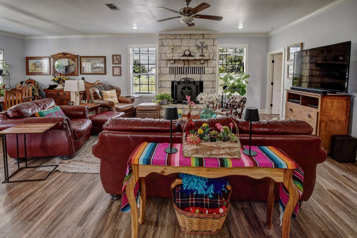 8500 Rosanky Road Waelder, TX 78959 - Photo 17 of 40 a living room with furniture a fireplace and a flat screen tv