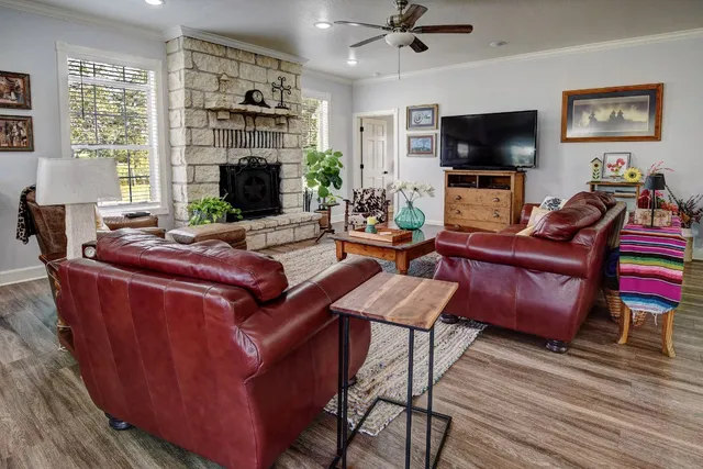 a living room with furniture a flat screen tv and a fireplace