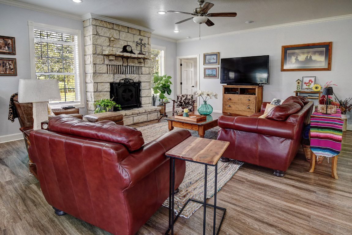 8500 Rosanky Road Waelder, TX 78959 - Photo 18 of 40 a living room with furniture a flat screen tv and a fireplace