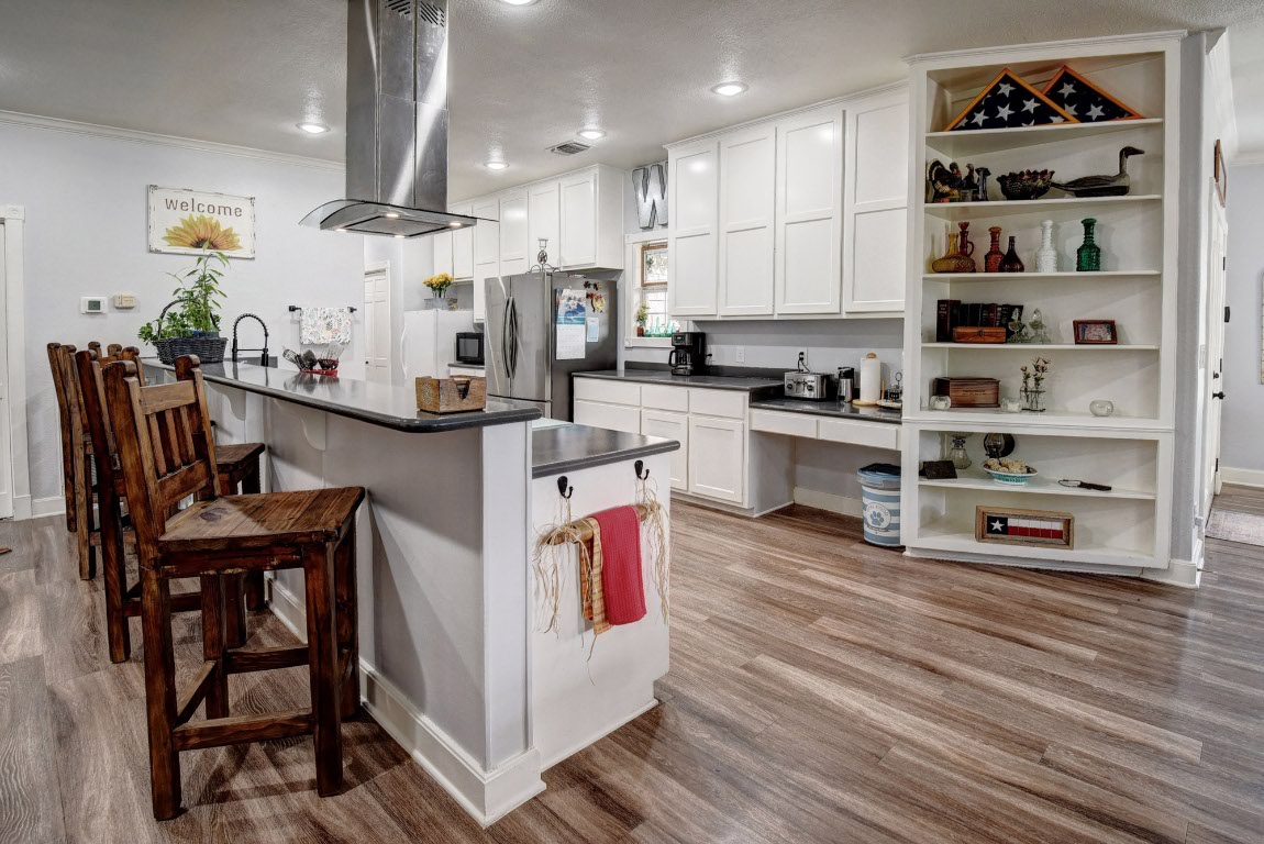 8500 Rosanky Road Waelder, TX 78959 - Photo 22 of 40 a kitchen with stainless steel appliances granite countertop a stove and cabinets