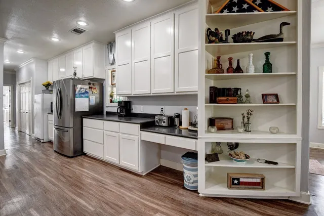 a kitchen with stainless steel appliances granite countertop a refrigerator and a stove top oven