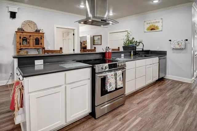 a kitchen with stainless steel appliances granite countertop a stove and a sink