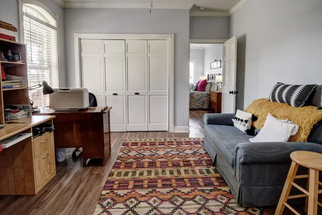 a bedroom with furniture and a window