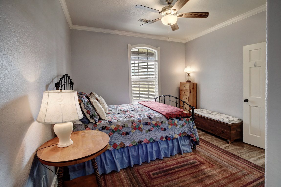 8500 Rosanky Road Waelder, TX 78959 - Photo 39 of 40 a bedroom with a bed and a chandelier