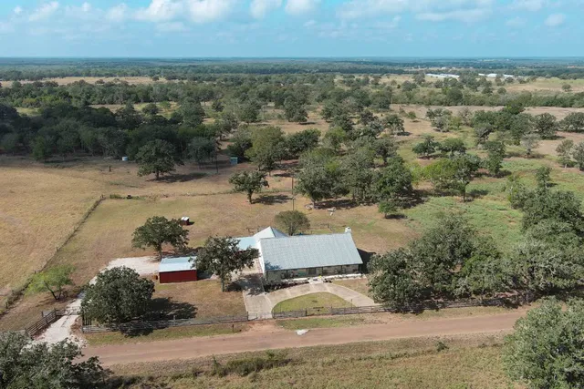 an aerial view of a house with a yard