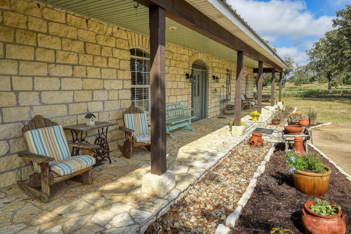 8500 Rosanky Road Waelder, TX 78959 - Photo 10 of 40 a view of a chair and tables in the patio with a backyard