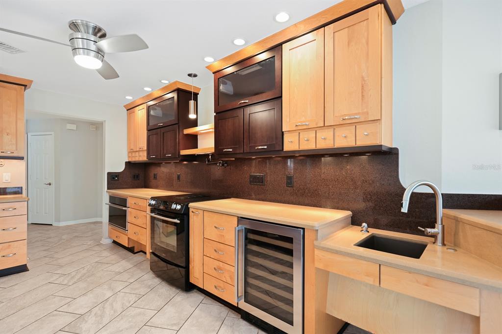 5208 Laurel Pointe Drive Valrico, FL 33596 - Photo 15 of 61 a kitchen with stainless steel appliances granite countertop a stove a sink and a microwave