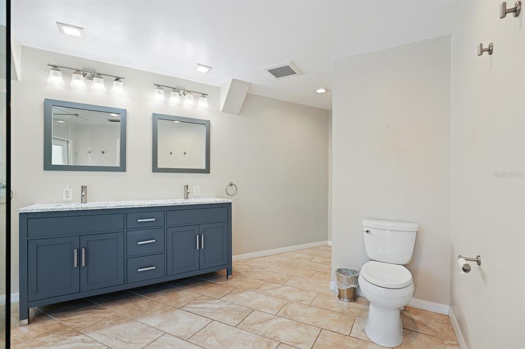 5208 Laurel Pointe Drive Valrico, FL 33596 - Photo 24 of 61 a bathroom with a toilet a sink and mirror