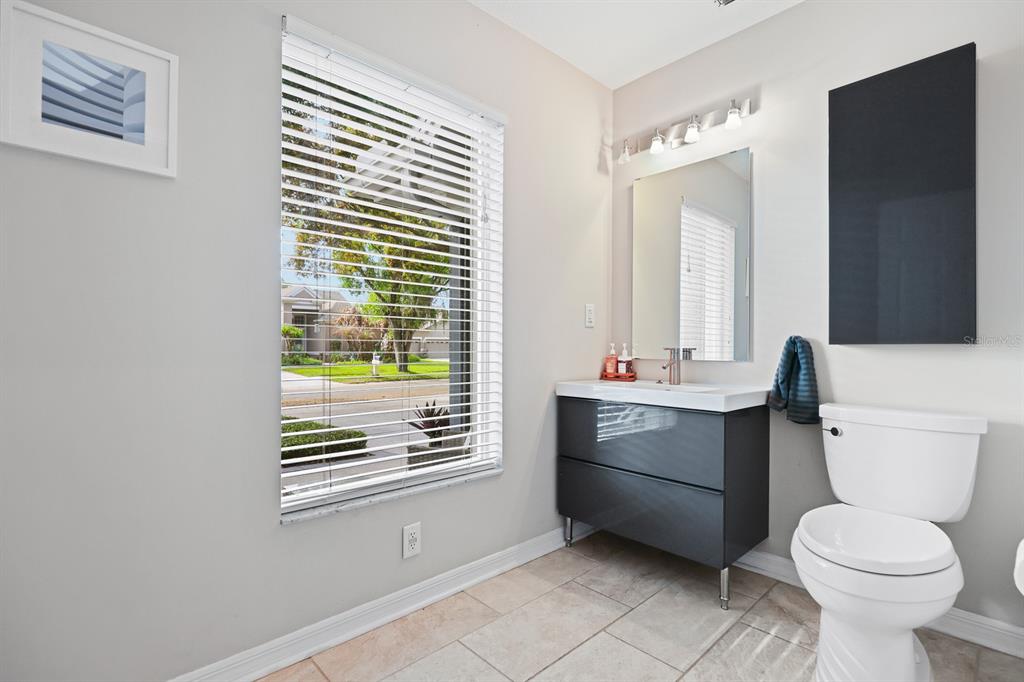 5208 Laurel Pointe Drive Valrico, FL 33596 - Photo 29 of 61 a bathroom with a toilet sink and mirror