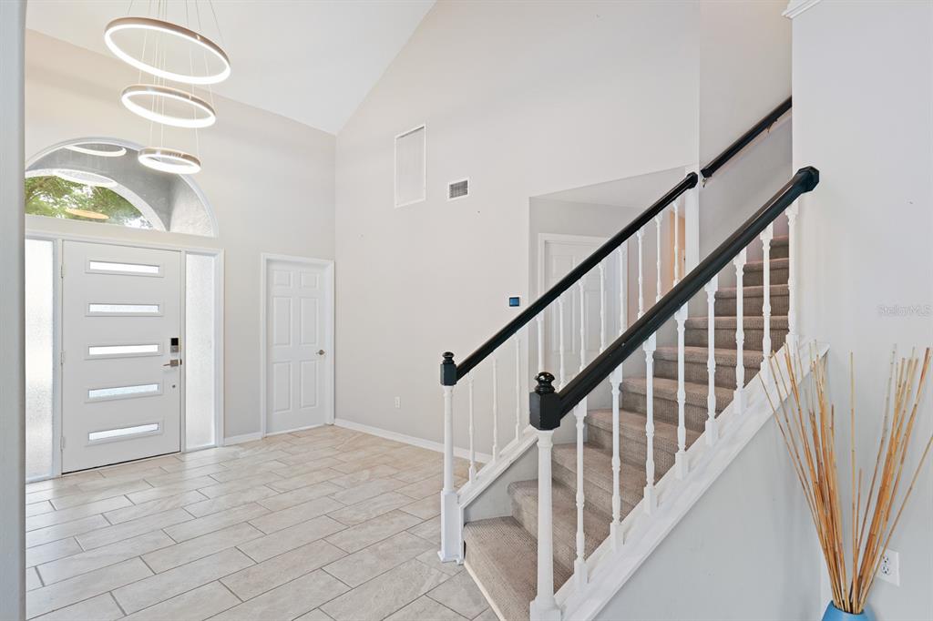 5208 Laurel Pointe Drive Valrico, FL 33596 - Photo 31 of 61 a view of staircase with lots of frames on wall and a window
