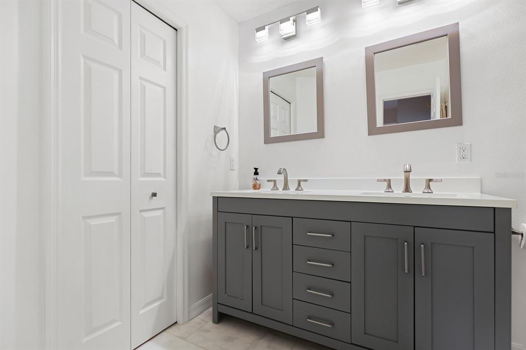 5208 Laurel Pointe Drive Valrico, FL 33596 - Photo 35 of 61 a bathroom with a double vanity sink and a mirror