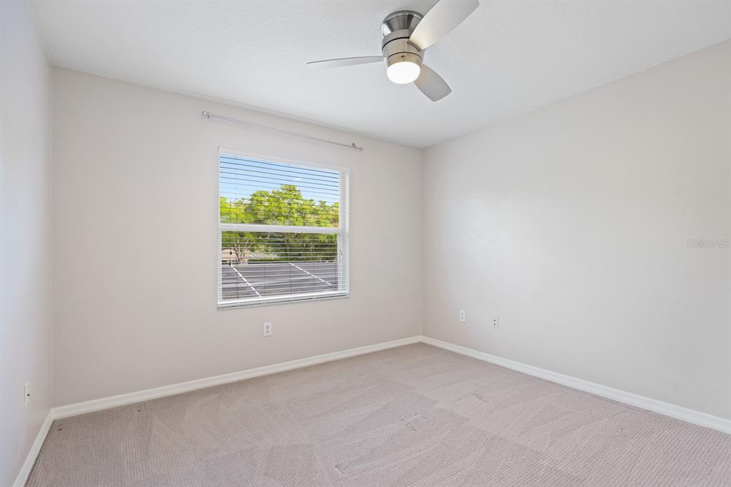 5208 Laurel Pointe Drive Valrico, FL 33596 - Photo 39 of 61 an empty room with a window and a ceiling fan