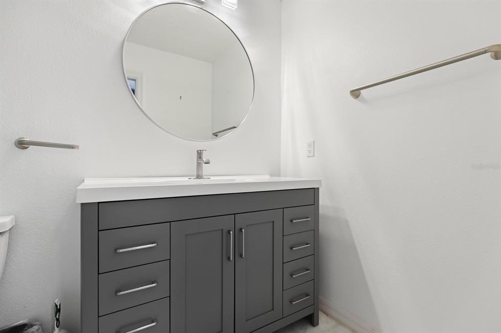 5208 Laurel Pointe Drive Valrico, FL 33596 - Photo 42 of 61 a bathroom with a sink vanity and a mirror