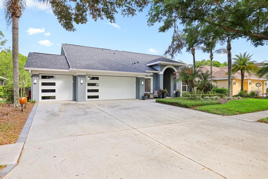 5208 Laurel Pointe Drive Valrico, FL 33596 - Photo 59 of 61 a front view of a house with a yard and garage