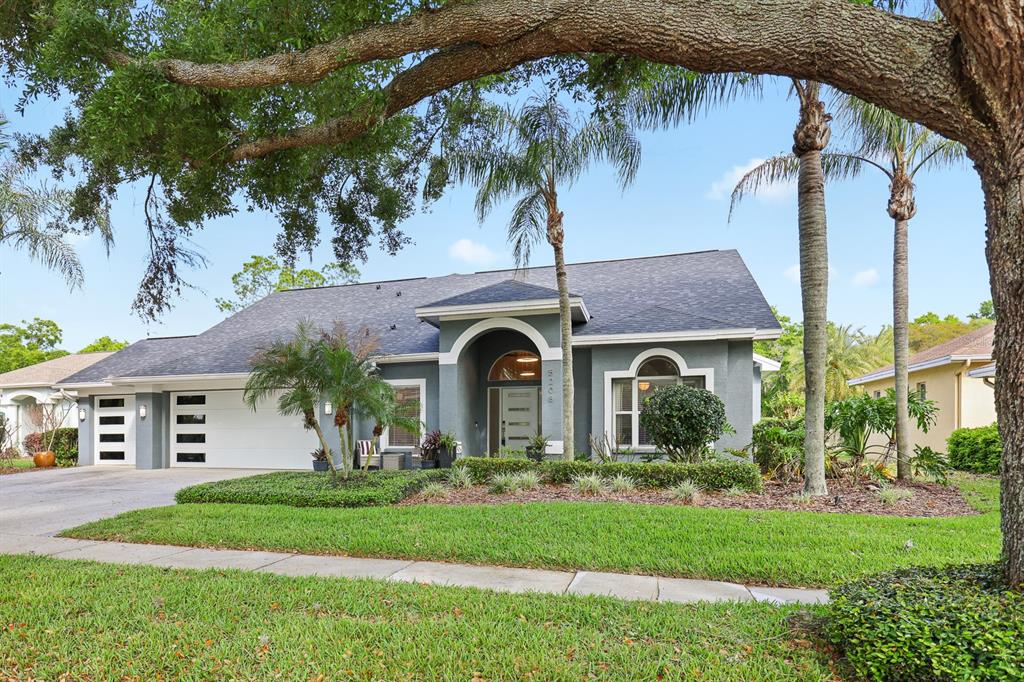 5208 Laurel Pointe Drive Valrico, FL 33596 - Photo 60 of 61 a front view of a house with a garden