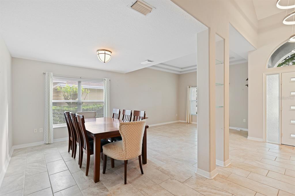 5208 Laurel Pointe Drive Valrico, FL 33596 - Photo 6 of 61 a view of a dining room with furniture and a window