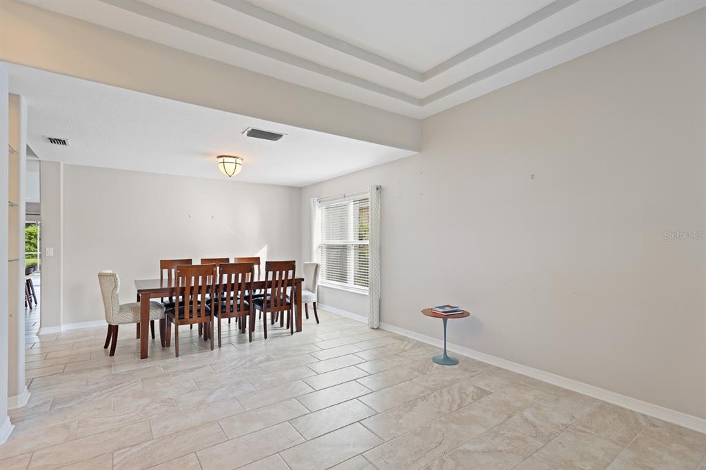 5208 Laurel Pointe Drive Valrico, FL 33596 - Photo 9 of 61 a dining room with furniture and a chandelier