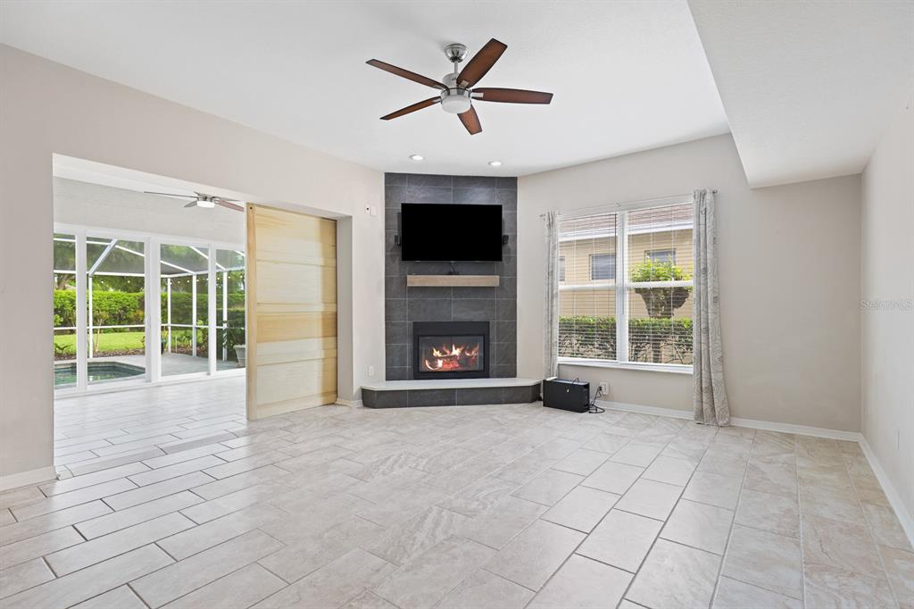 5208 Laurel Pointe Drive Valrico, FL 33596 - Photo 10 of 61 a view of an empty room with a fireplace and a large window
