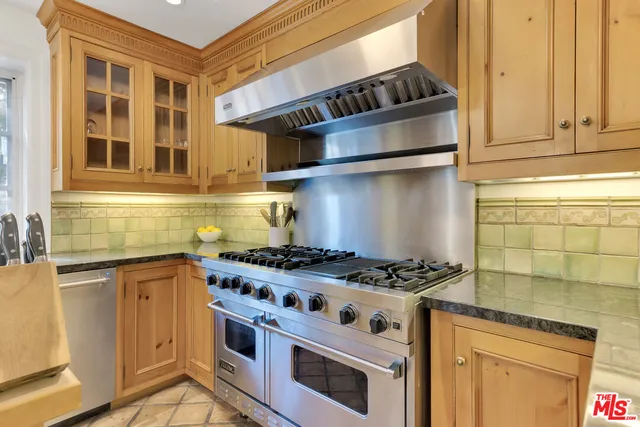 a dining room with furniture a chandelier and window