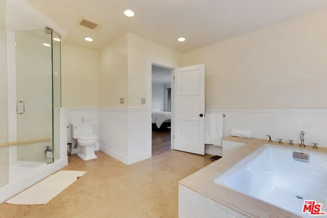 a large white bed in a white room