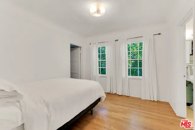 a car parked in front of a white house