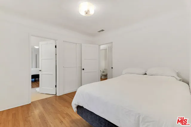 a view of a house with backyard and a tree