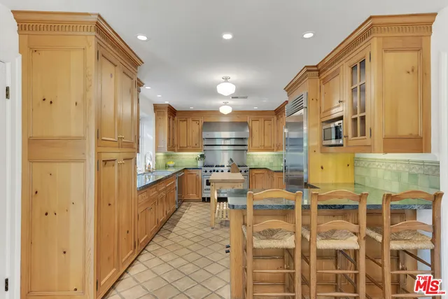 a kitchen with stainless steel appliances granite countertop a stove and a sink