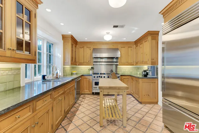a kitchen with a stove and a white cabinet