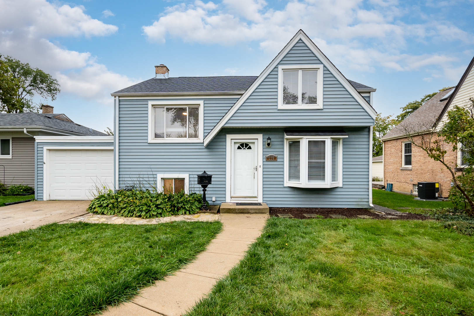a front view of a house with a yard and porch