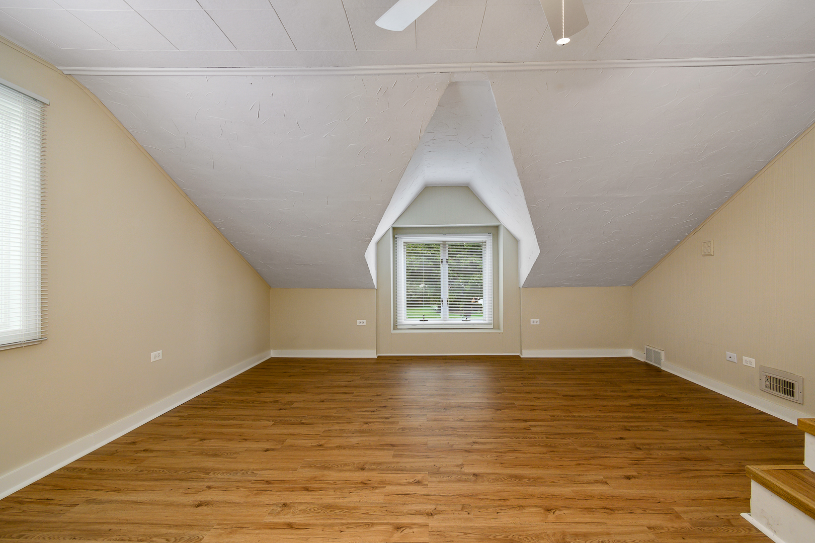 235 West Hickory Road Lombard, IL 60148 - Photo 13 of 23 a view of an empty room with wooden floor and a window